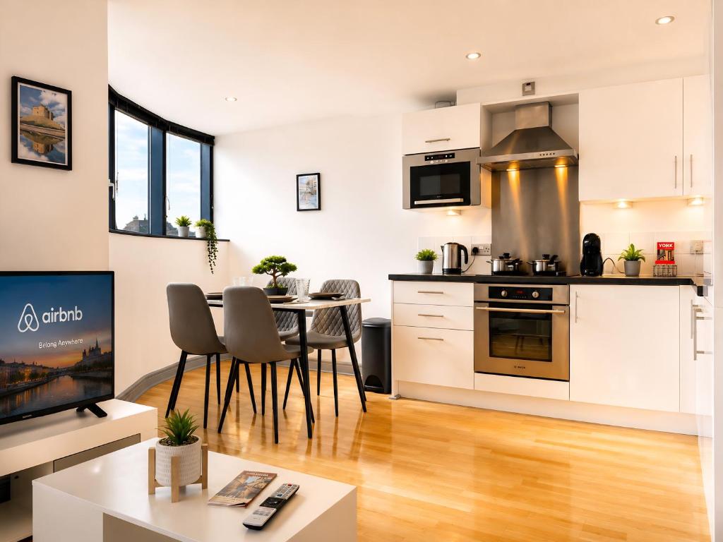 a kitchen and living room with a table and chairs at York City Centre 1-bed Apartment Near Q-Park Parking - Best Location in York