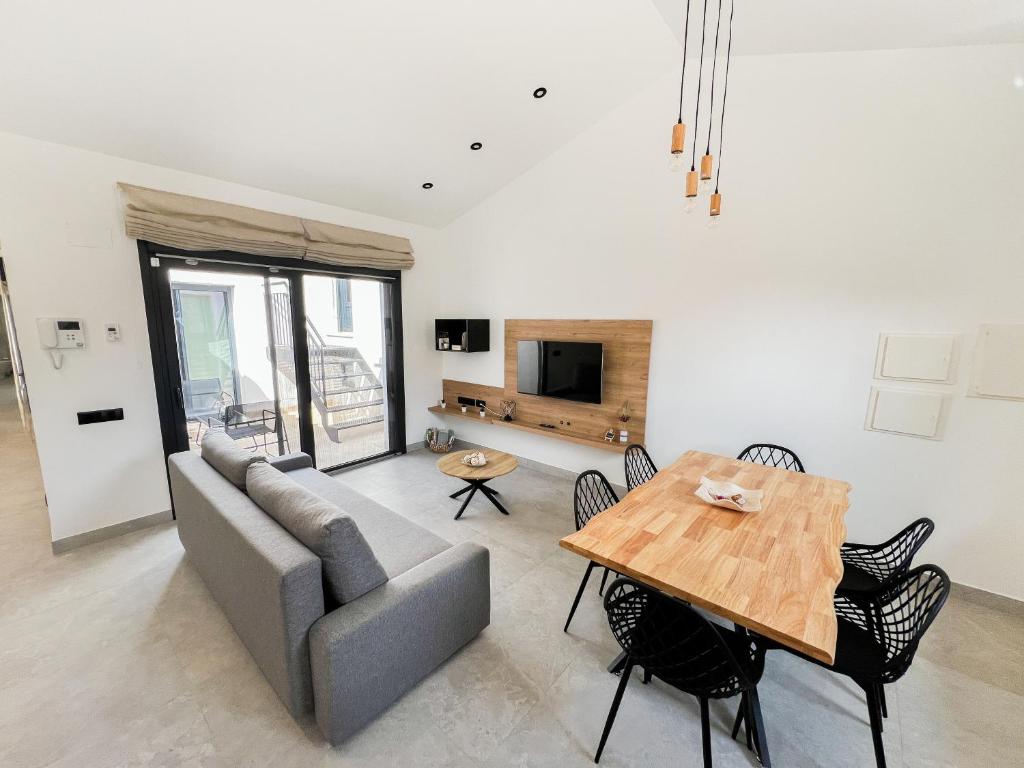a living room with a couch and a table at Apartamentos llerda in Cretas