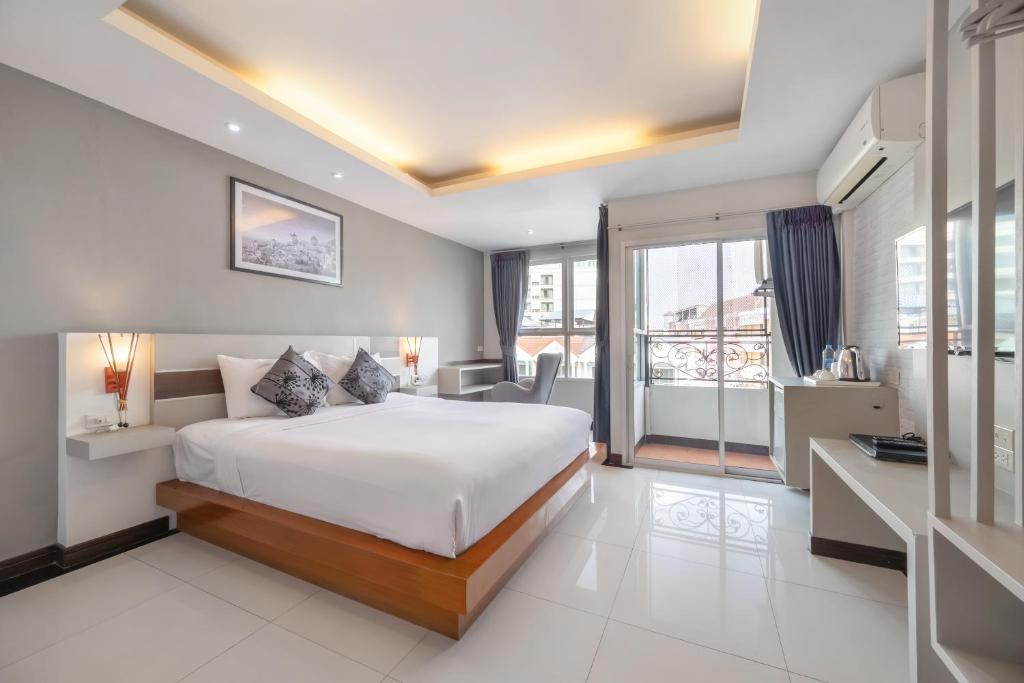 a hotel room with a bed and a balcony at V Style Pattaya North Beach in Pattaya