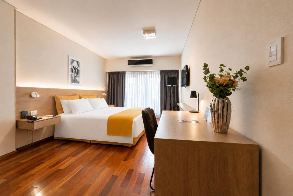 a hotel room with a bed and a desk at Feir's Park Hotel & Rooftop in Buenos Aires