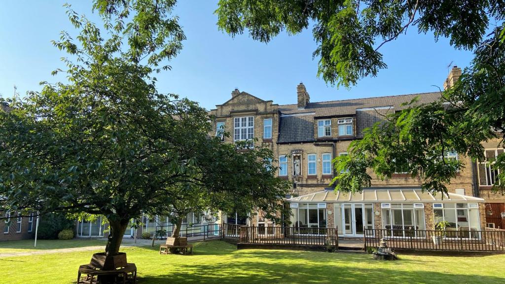 a large building with a tree in front of it at Endsleigh Park Hotel in Hull