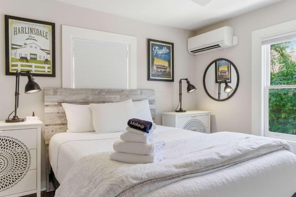 a bedroom with a white bed with towels on it at Pasture Bedtime in Franklin