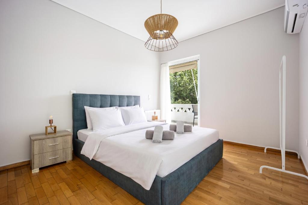 a bedroom with a large bed and a window at City Center Calm Spot in Athens