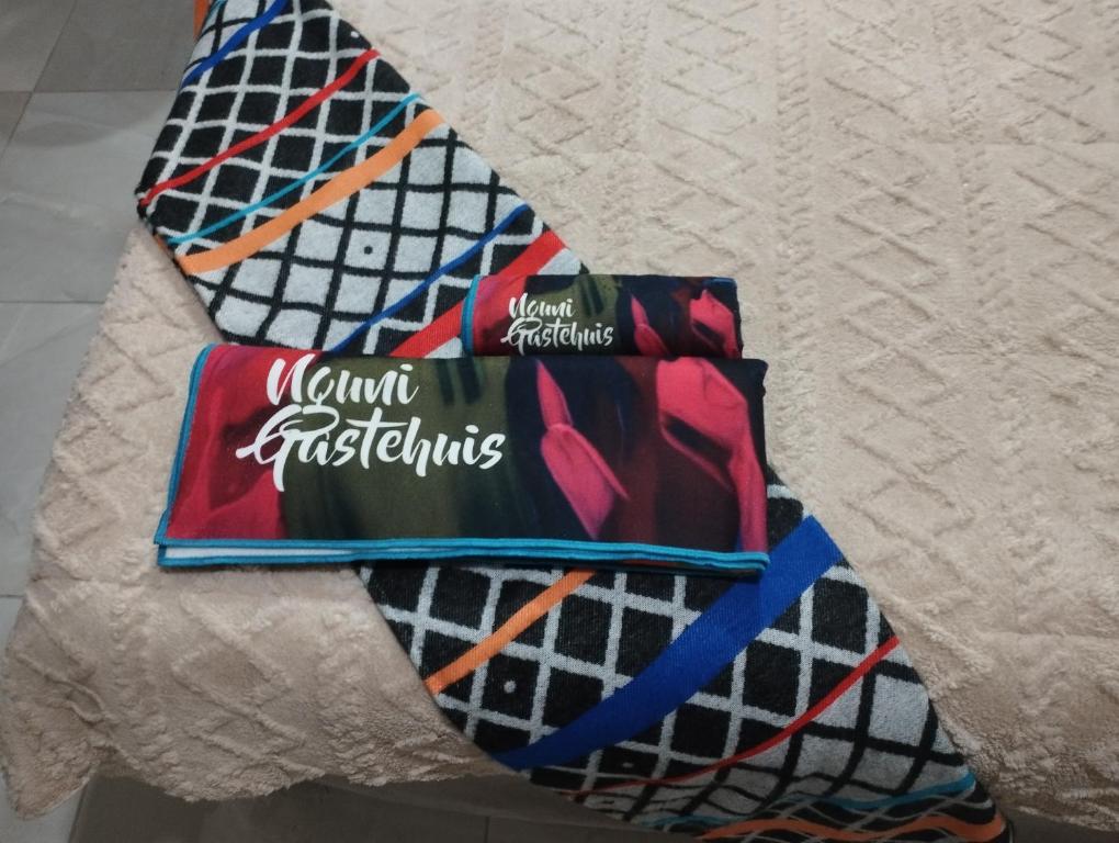a group of ties sitting on a piece of paper at Nguni Gaste Huis in Mooinooi