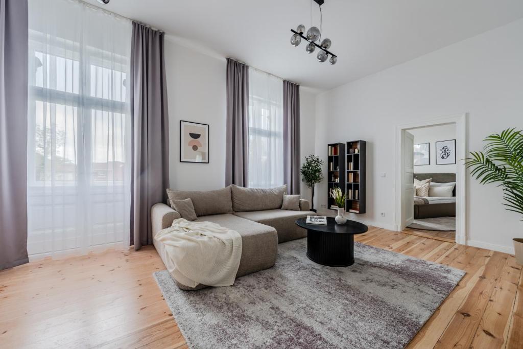 a living room with a couch and a table at Potsdam Classic Apartment in Potsdam