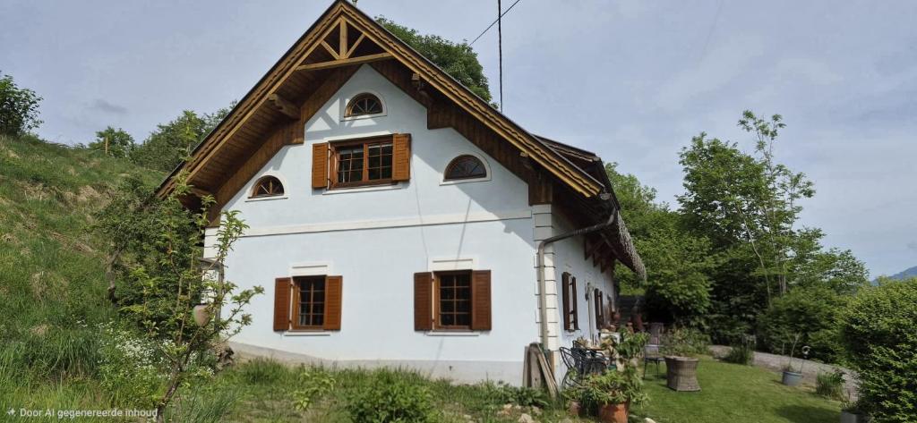 a white house with windows on a hill at Landhaus Rickies in Aifersdorf