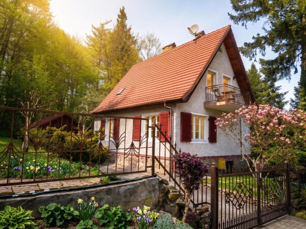 a small house with a red roof at Gawra Bogusza in Lądek-Zdrój