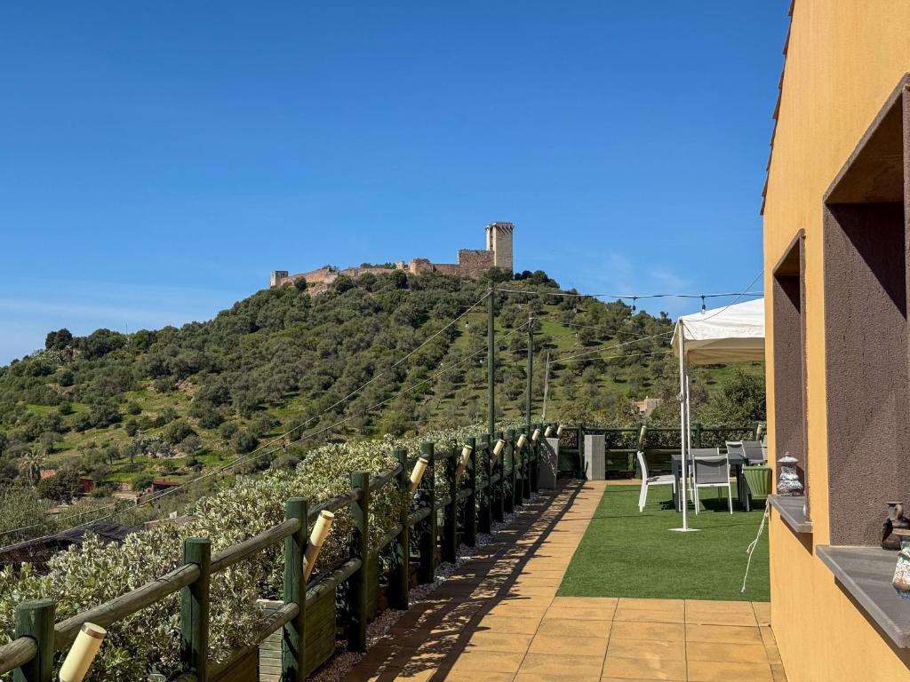 a view of a hill with a castle on top at Giardini Malaspina in Bosa