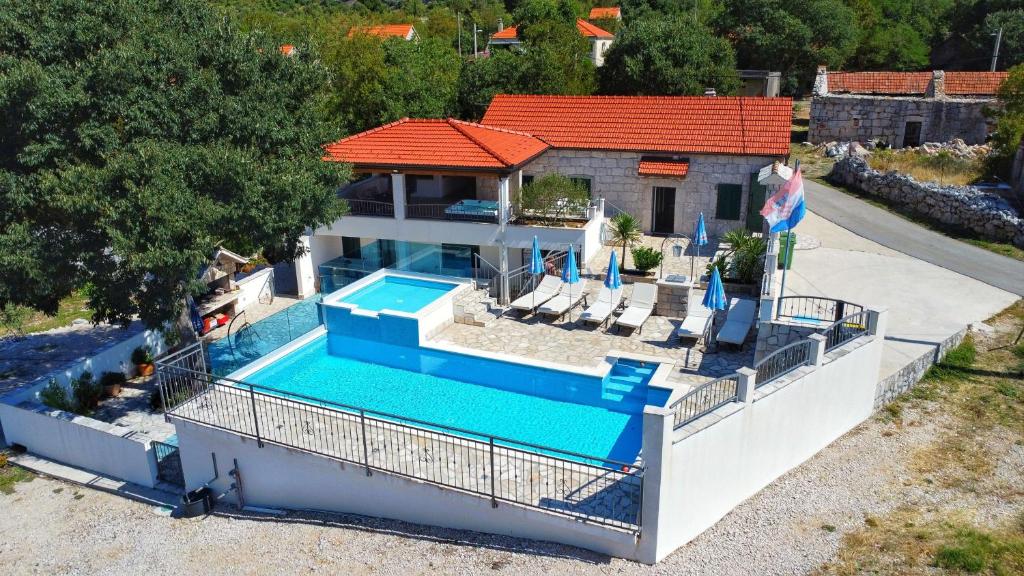 an aerial view of a house with a swimming pool at Villa Solaris in Donje Rašćane
