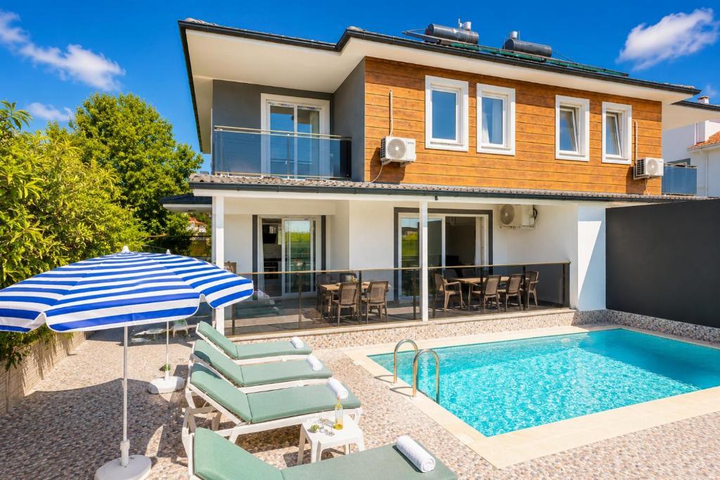a villa with a swimming pool and a house at Villa Azalea 1 in Ortaca