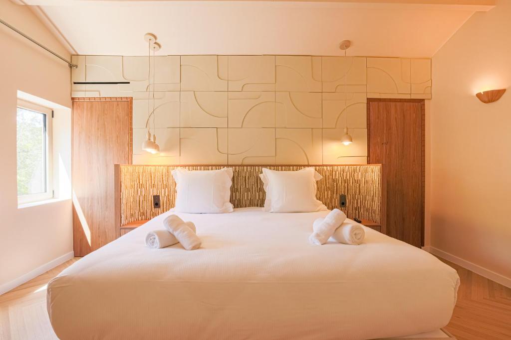 a bedroom with a large white bed with towels on it at Casa Liana Saint-Tropez in Saint-Tropez