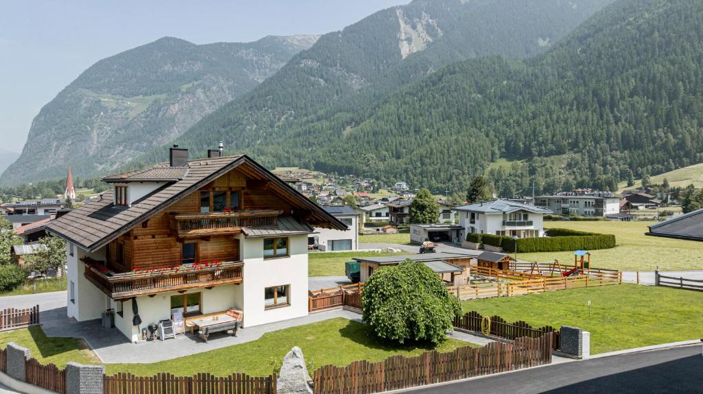 a house with a mountain in the background at Ferienhaus Tirol im Ötztal in Umhausen