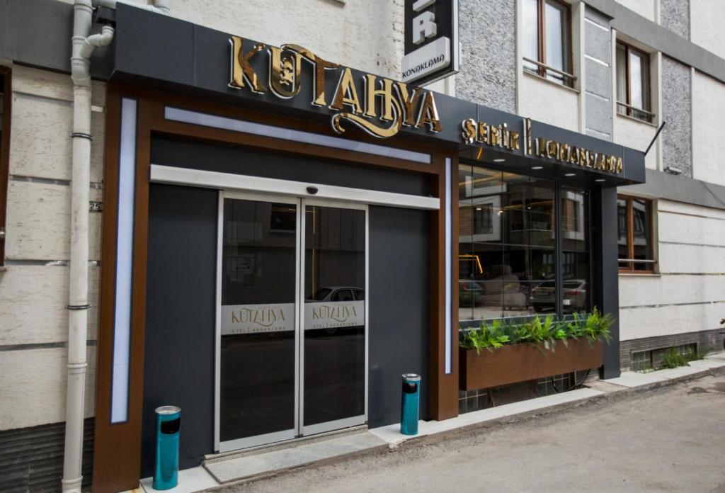 a restaurant with a sign on the front of a building at Kütahya Şehir Otel in Kütahya
