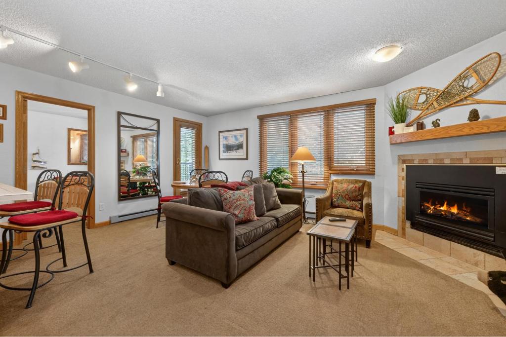 a living room with a couch and a fireplace at Iron Horse Building D Unit 4104 in Winter Park