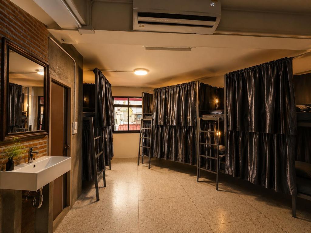 a bathroom with a sink and a counter with shelves at TUKTUK Home in Samphanthawong