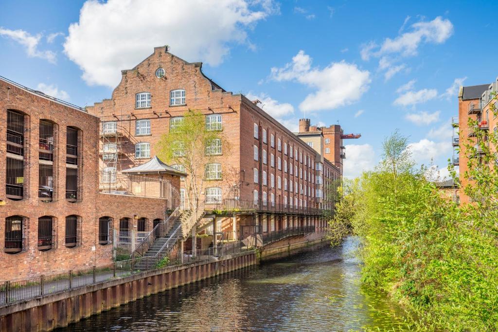 a river in a city with buildings and a canal at York Cocoa Suites - city centre apartments in York