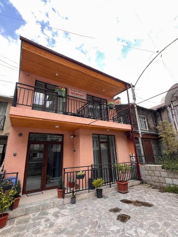a building with a balcony with plants on it at Memory- borjomi in Borjomi
