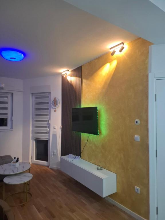 a living room with a flat screen tv on a wall at Apartman M&Ð Foca-free parking garage in Foča