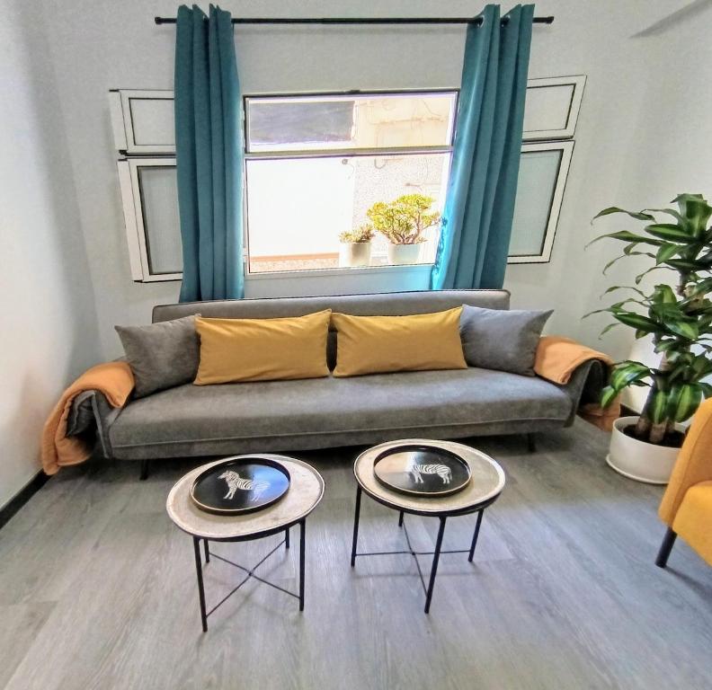 a living room with a couch and two tables at Nido De Mar in Santidad