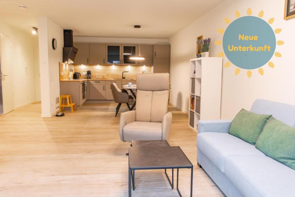 a living room with a couch and a kitchen at Hyggehuus Tossens - Küste33 41 in Tossens