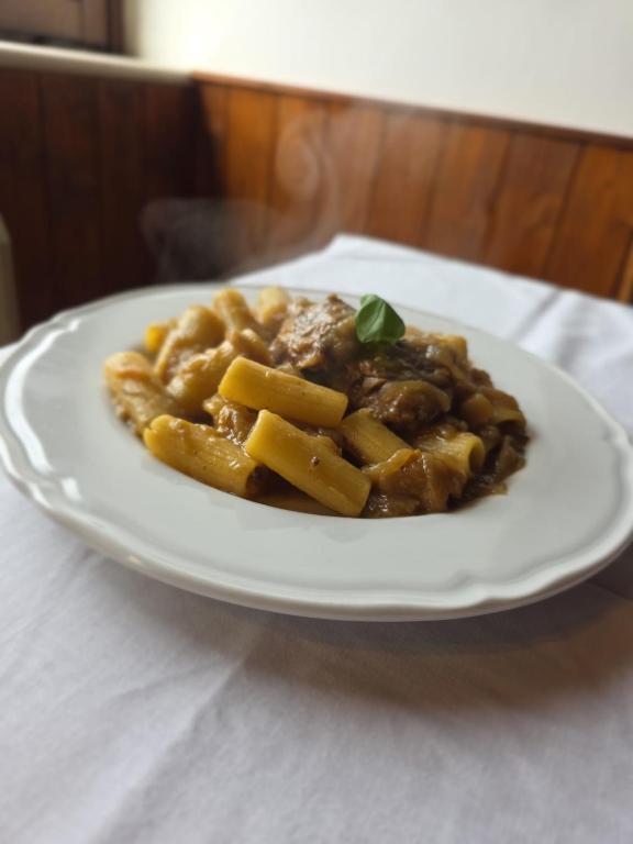 a plate of food with pasta on a table at hotel il ghiro in Ovindoli