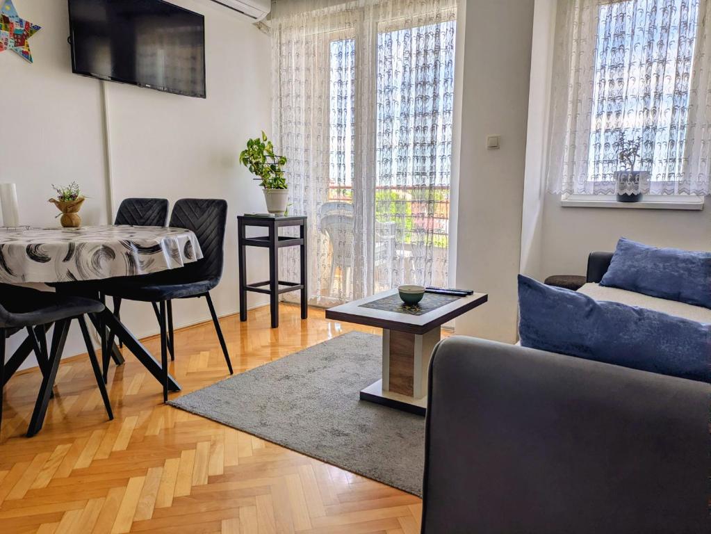 a living room with a couch and a table at Venus Apartman in Brčko