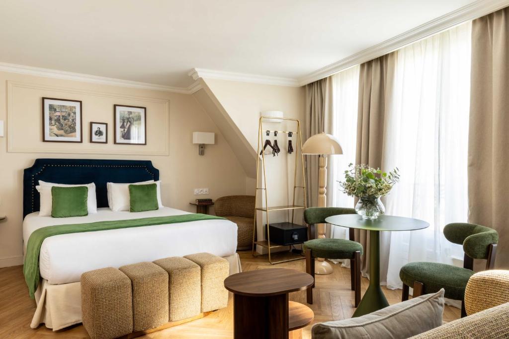 a hotel room with a bed and a table at Hotel Du Flaneur in Paris