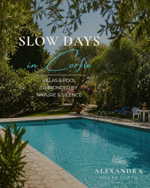 a sign that says slow days in club with a swimming pool at Alexandra villas in Gouvia