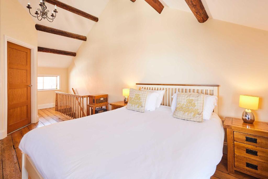a bedroom with a large white bed with two pillows at Host & Stay - Sea Haven in Staithes