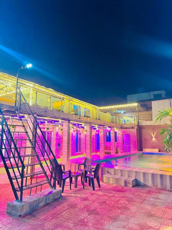 a building with a staircase and a train at night at Baba s Villa in Lonavala
