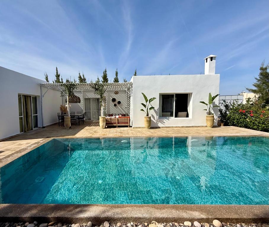 a swimming pool in front of a villa at Villa TerraVerde in Al Ghar