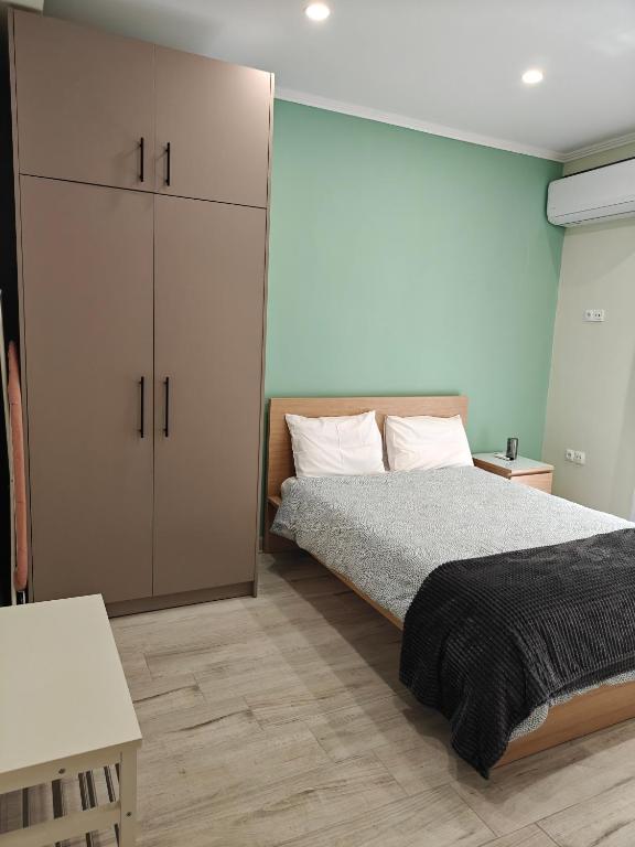 a bedroom with a bed and a large cabinet at Central Modern Living Apartment 1 in Eleftheroúpolis