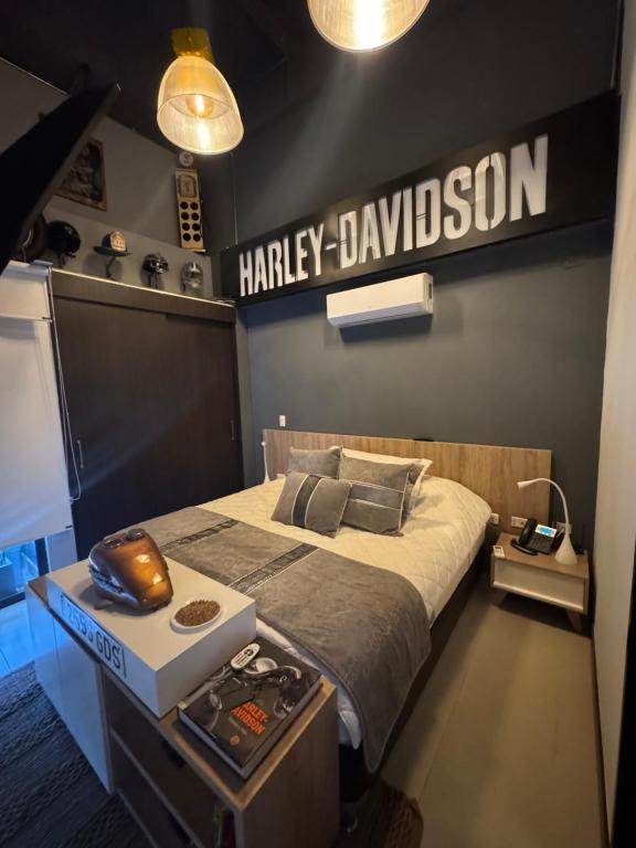 a bedroom with a harley davidson sign on the wall at Hotel Rioverde Loft cerca De Aeropuerto Jmc in Rionegro