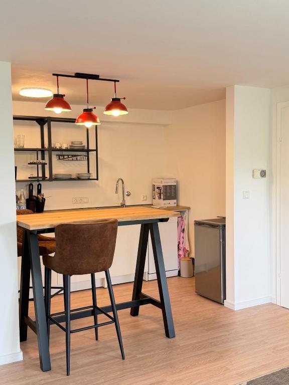 a kitchen with a wooden table with a chair at Apartment Am Wald in Idar-Oberstein