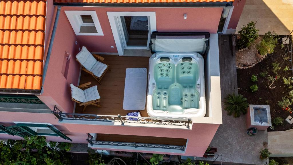 an aerial view of a house with a bath tub at Captain's Escape - Spa City View in Mali Lošinj