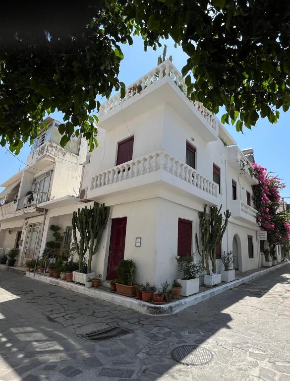 a white building with plants in front of it at Almyra Summer Homes in Ierapetra