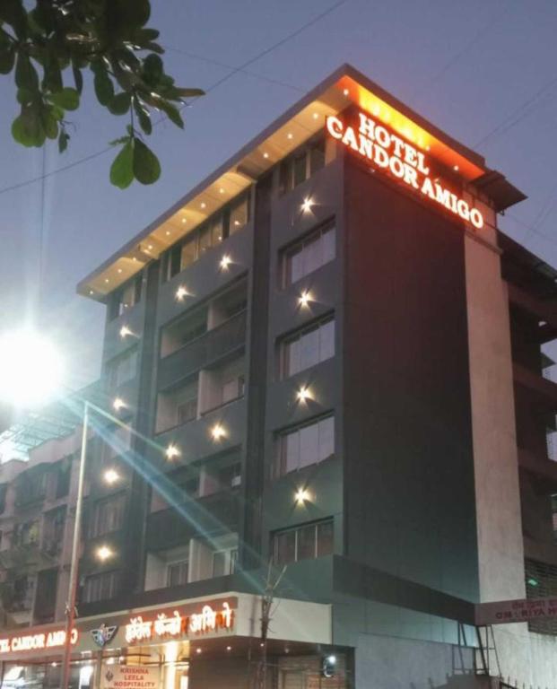 a building with a sign on top of it at Hotel Candor Amigo Kamothe Panvel in Navi Mumbai