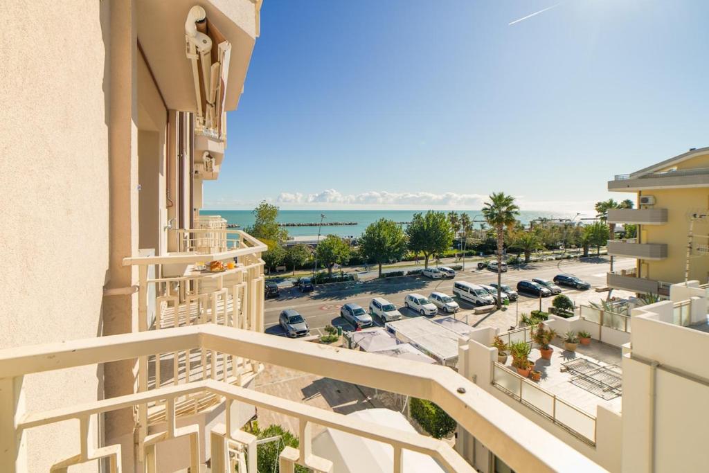 an apartment balcony with a view of a parking lot at Bambinopoli Al Mare in Alba Adriatica