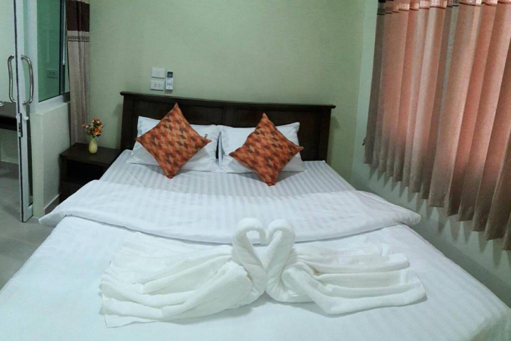 a bed with two towels in the shape of hearts at The Best Place in Samutprakarn