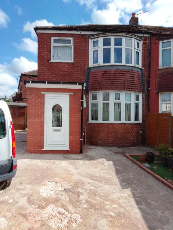 a red brick house with a white door at Morgan Ease in Manchester