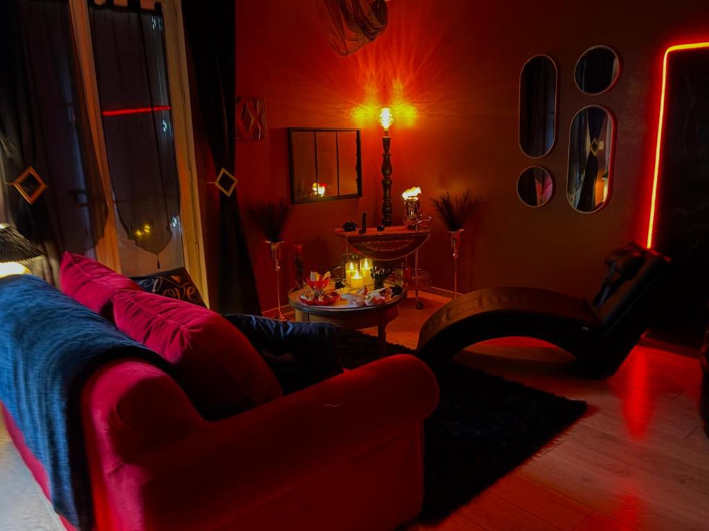 a red living room with a couch and a table at Maison love rooms in Tours
