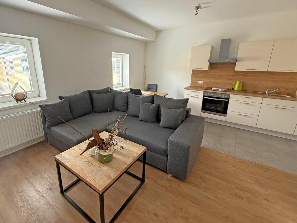 a living room with a couch and a table at Ferienwohnung in Seenähe! in Timelkam