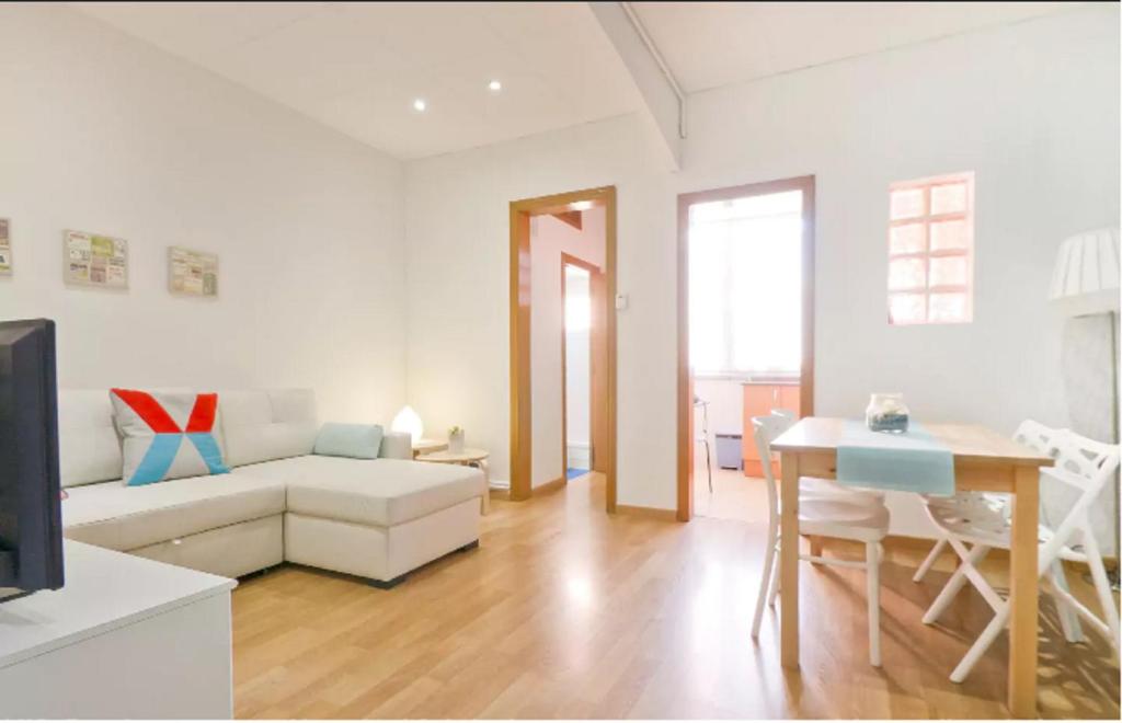 a living room with a couch and a table at Sea Apartament in Sant Adria de Besos