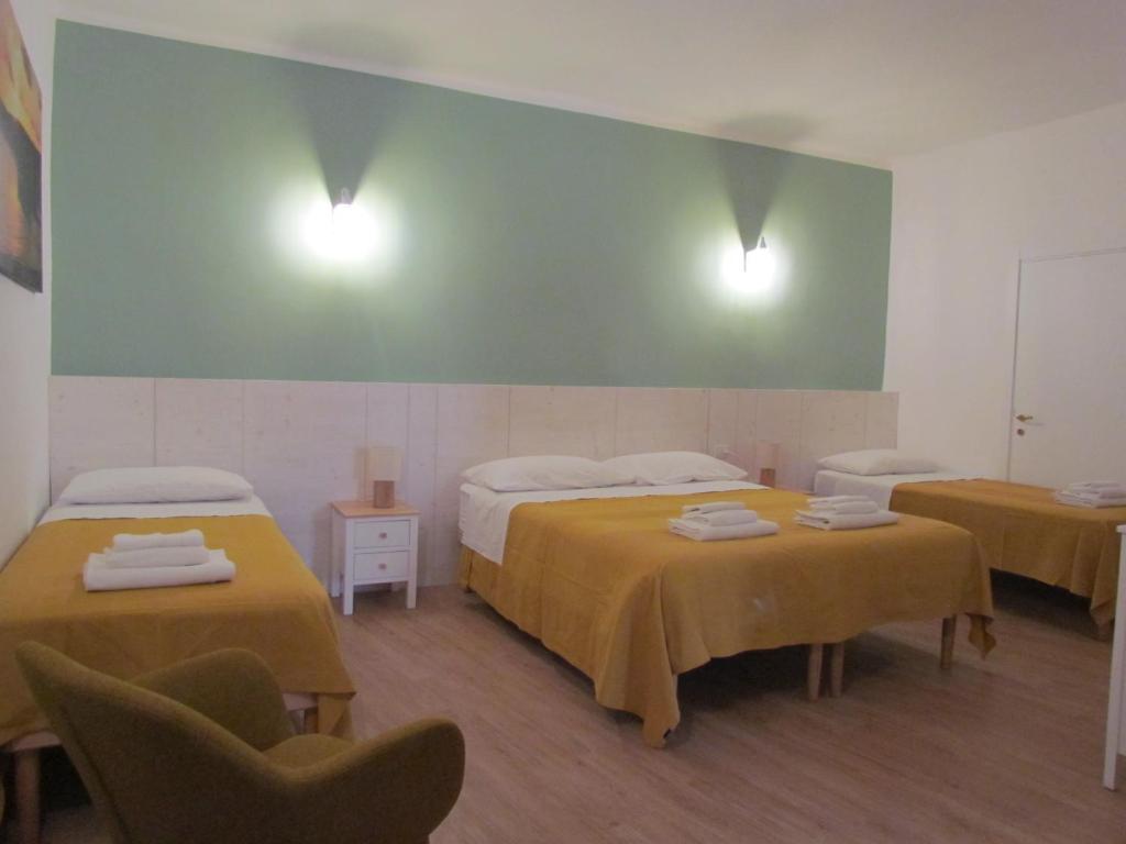 a room with two beds and two chairs at Arco Michele in Putignano
