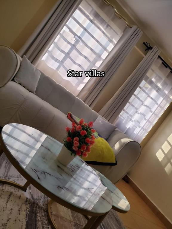 a living room with a couch and a glass table at Star Villas Nyahururu in Nyahururu