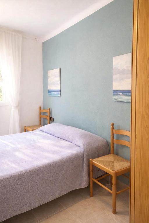 a bedroom with a bed and a chair at Rooms in Palma Center in Palma de Mallorca