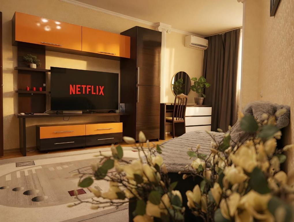 a living room with a tv and a couch in a room at RentHouse Apartments Metropolis in Chişinău