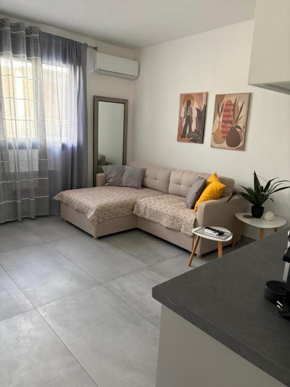 a living room with a couch and a table at Olympia's Guest House in Volos