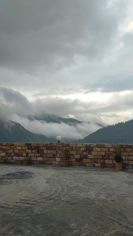 a brick wall with potted plants on top of it at Hotel comfort hill in Abbottabad