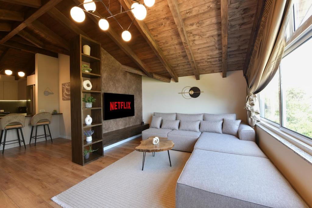 a living room with a couch and a table at Villa Madera in Shirokë